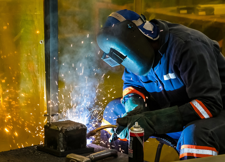 A male working with a welding torch
